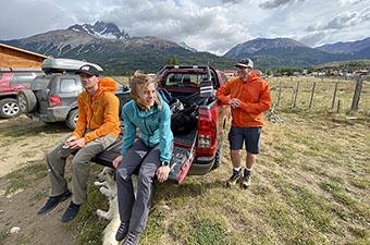 The Switchback team sitting on a truck tailgate at a windy trailhead